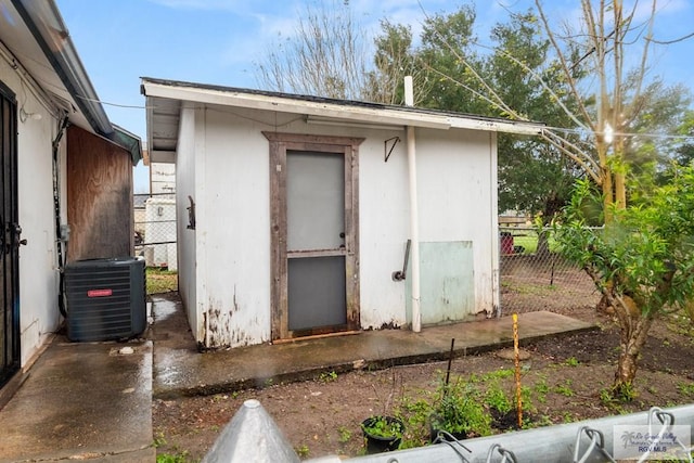 view of shed featuring central AC and fence