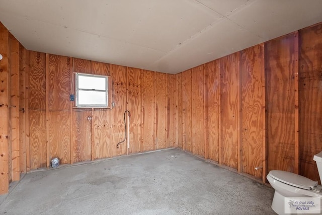 empty room featuring wooden walls