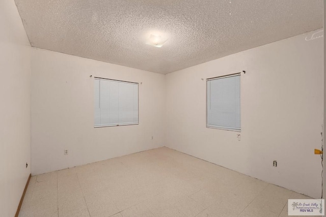 empty room featuring a textured ceiling