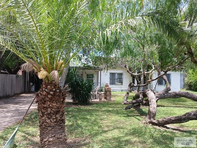 609 E Filmore Ave, Harlingen, TX 78550 - obstructed view of property featuring a front lawn