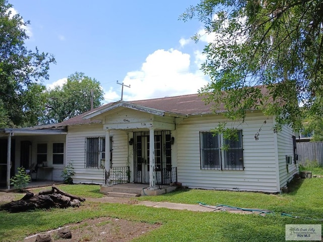 609 E Filmore Ave, Harlingen, TX 78550 - rear view of house with a lawn