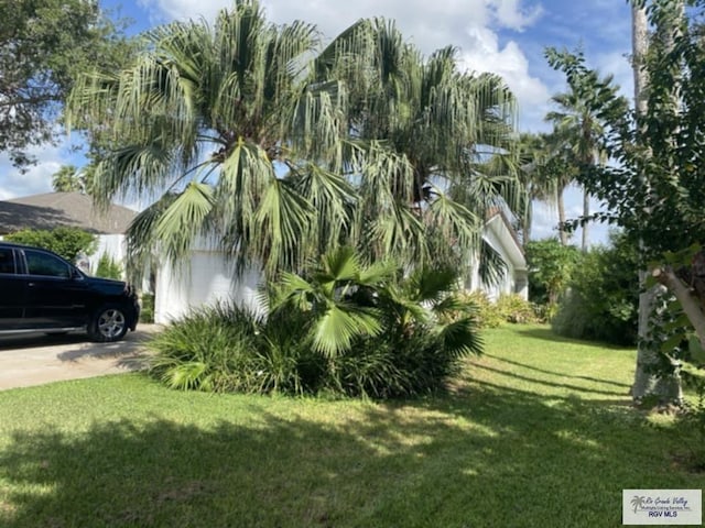 view of home's exterior featuring a garage and a lawn