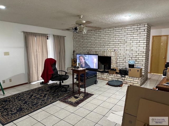 tiled living room with ceiling fan, a fireplace, and a textured ceiling