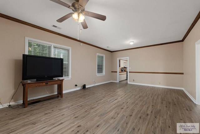 unfurnished living room with crown molding and hardwood / wood-style floors