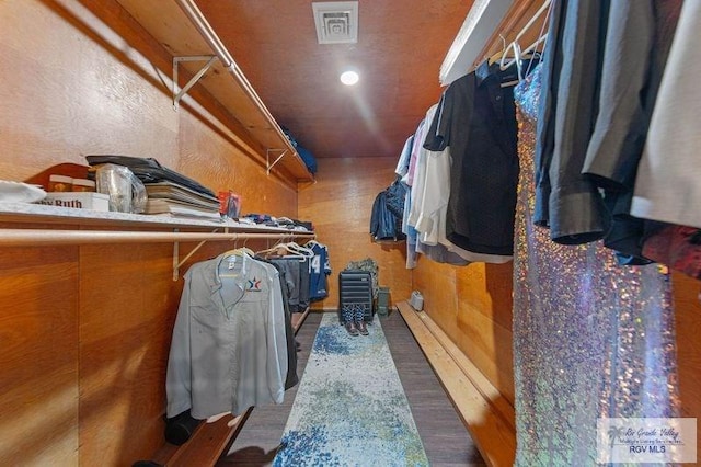 spacious closet featuring dark hardwood / wood-style floors