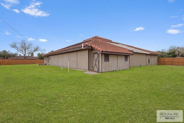 back of house with a yard