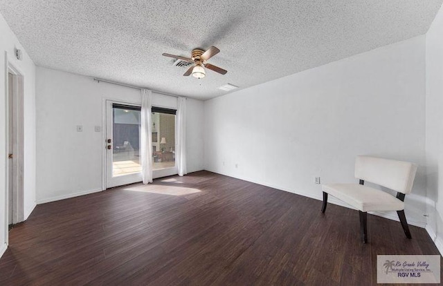 interior space with dark wood-type flooring, ceiling fan, and a textured ceiling