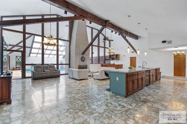 kitchen with pendant lighting, an inviting chandelier, high vaulted ceiling, expansive windows, and beam ceiling