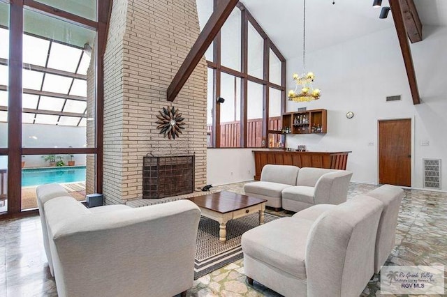 living room featuring a towering ceiling and a healthy amount of sunlight