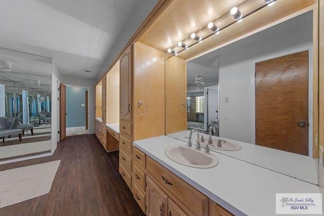 bathroom featuring vanity, hardwood / wood-style floors, and ceiling fan