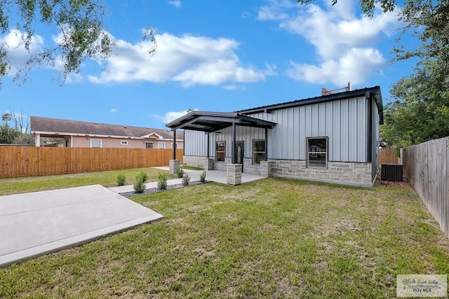 rear view of house featuring central AC, a yard, and a patio