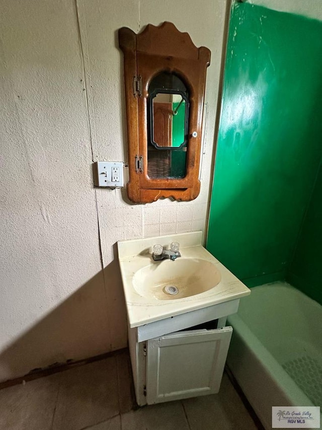 1022 E Monroe Ave, Harlingen, TX 78550 - full bathroom featuring vanity, a bath, and tile patterned flooring