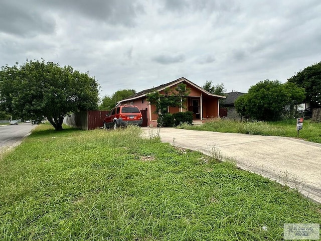 1022 E Monroe Ave, Harlingen, TX 78550 - view of property hidden behind natural elements featuring driveway and fence
