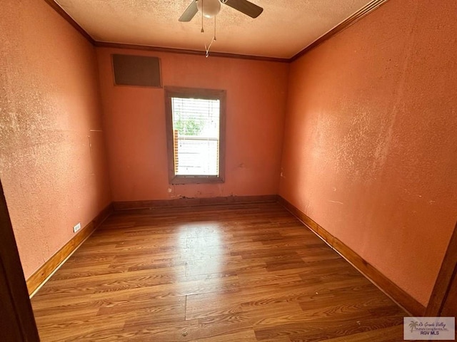 1022 E Monroe Ave, Harlingen, TX 78550 - unfurnished room featuring a textured ceiling, ornamental molding, a textured wall, wood finished floors, and a ceiling fan