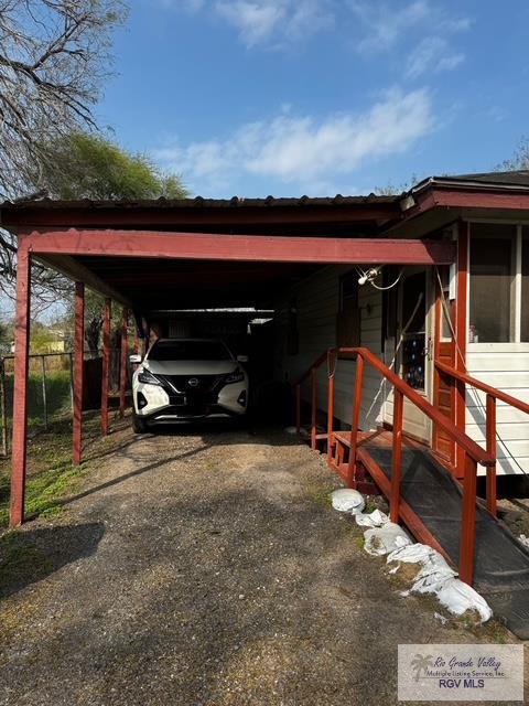 view of parking / parking lot with a carport