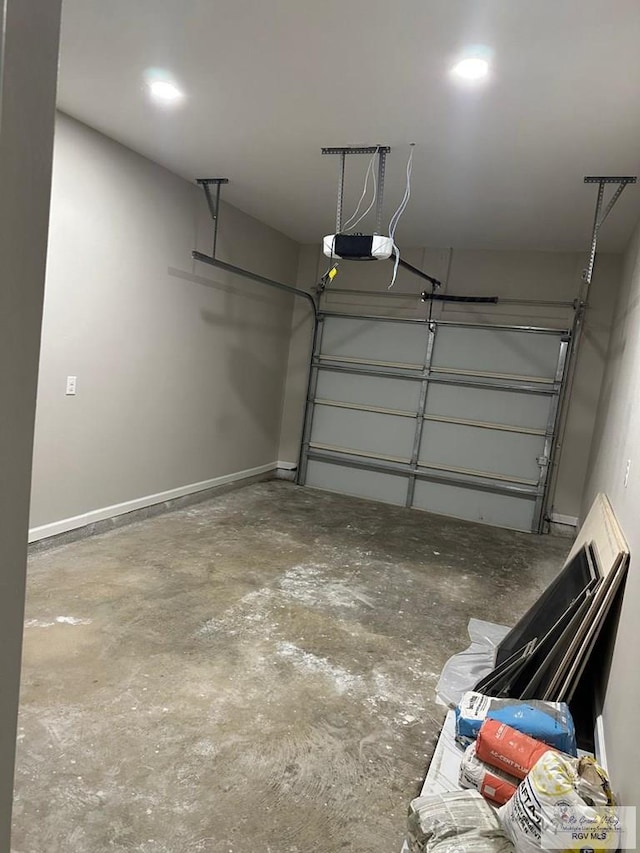 garage featuring baseboards and a garage door opener