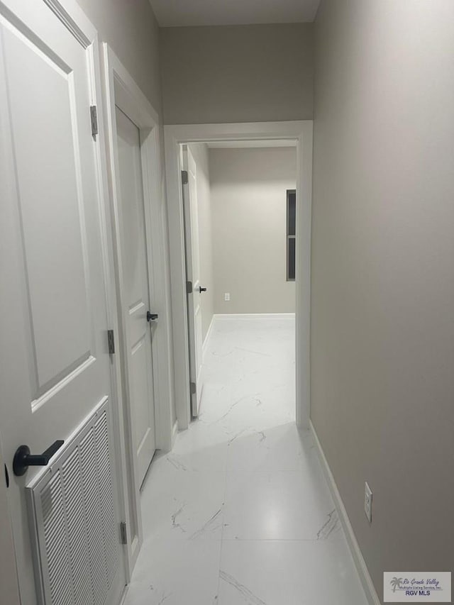 corridor with marble finish floor, baseboards, and visible vents