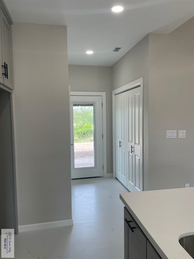 interior space featuring recessed lighting, gray cabinets, light countertops, visible vents, and baseboards