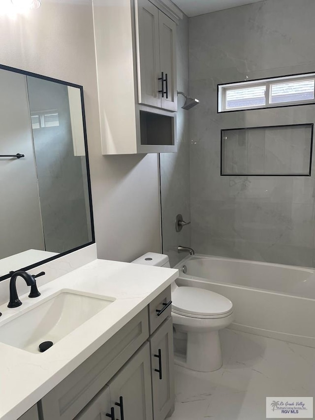 full bath with marble finish floor, shower / bathing tub combination, vanity, and toilet