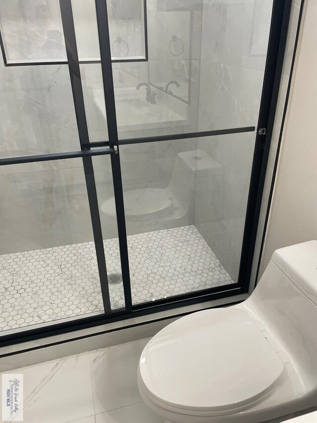 full bath with a stall shower and toilet