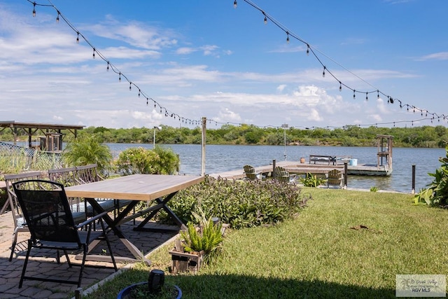 dock area with a yard and a water view