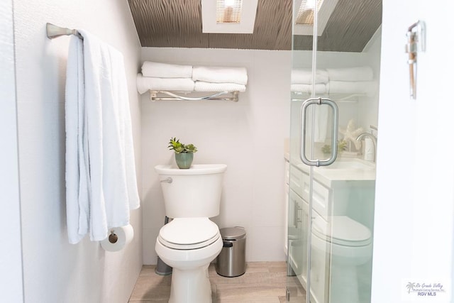 bathroom featuring hardwood / wood-style floors, toilet, and walk in shower