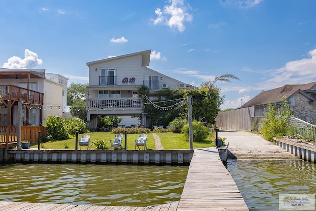 view of dock featuring a yard and a water view