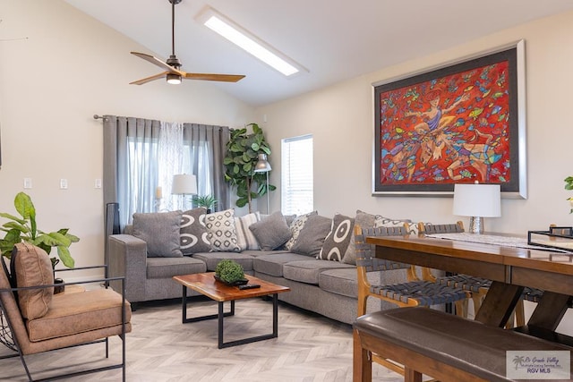 living room with ceiling fan, lofted ceiling, and light parquet floors