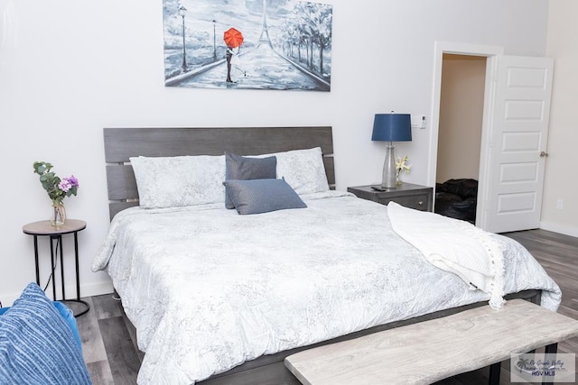 bedroom with dark wood-type flooring