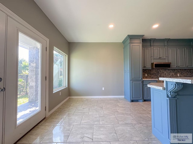 kitchen with light stone countertops and backsplash