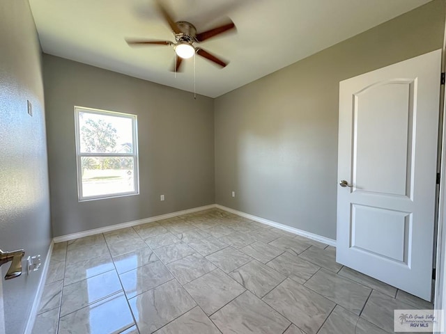 spare room with ceiling fan