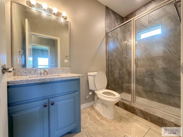 bathroom featuring vanity, an enclosed shower, and toilet