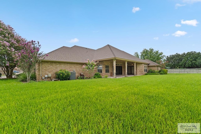 14823 S Valencia Cir, Harlingen, TX 78552 - rear view of property with brick siding and a patio