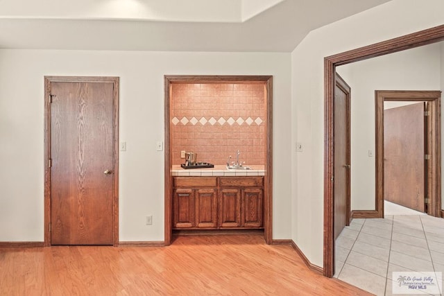 14823 S Valencia Cir, Harlingen, TX 78552 - indoor wet bar featuring light wood-type flooring and baseboards
