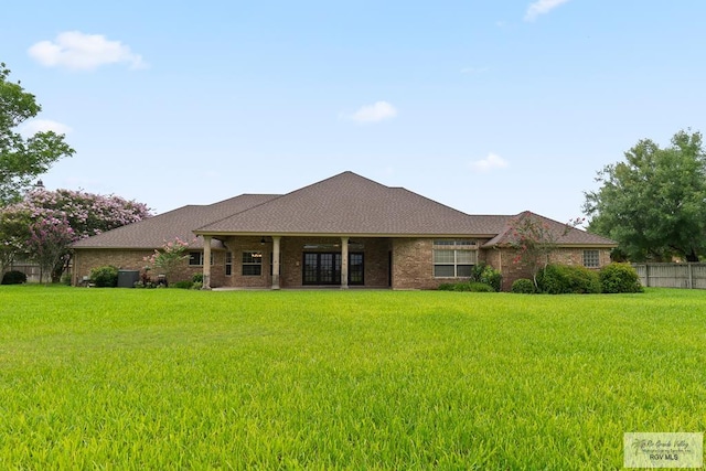 14823 S Valencia Cir, Harlingen, TX 78552 - back of house featuring brick siding and roof with shingles