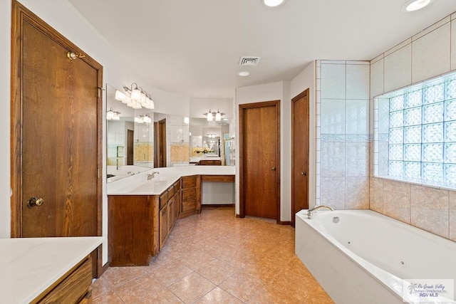 14823 S Valencia Cir, Harlingen, TX 78552 - bathroom with a whirlpool tub, vanity, tile patterned flooring, and recessed lighting