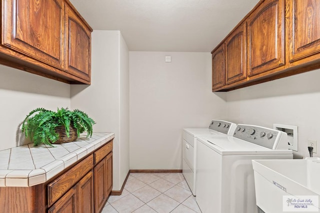 14823 S Valencia Cir, Harlingen, TX 78552 - washroom featuring washer and dryer, light tile patterned floors, and cabinet space