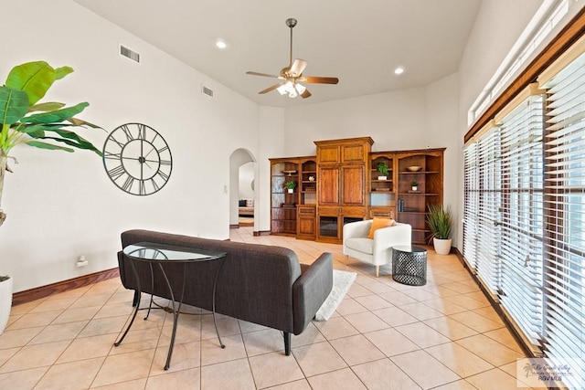 14823 S Valencia Cir, Harlingen, TX 78552 - living area featuring ceiling fan, arched walkways, a high ceiling, light tile patterned flooring, and recessed lighting