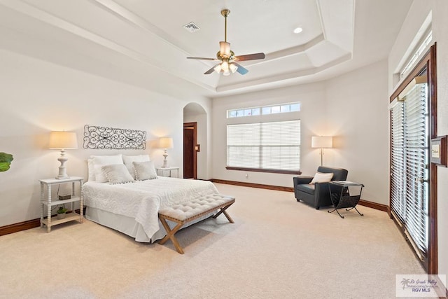 14823 S Valencia Cir, Harlingen, TX 78552 - bedroom featuring a raised ceiling, light carpet, arched walkways, and ceiling fan