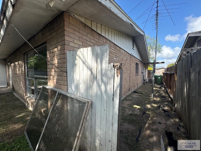 20 Casa Linda Unit 20, Brownsville, TX 78526 - view of property exterior featuring brick siding and a central air condition unit