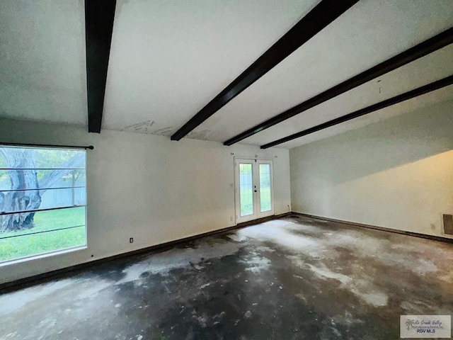 20 Casa Linda Unit 20, Brownsville, TX 78526 - empty room featuring beamed ceiling, unfinished concrete flooring, and french doors