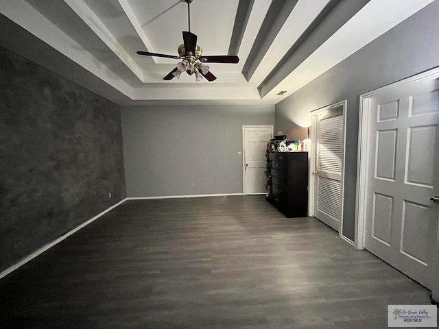1822 Nasa, Brownsville, TX 78521 - unfurnished bedroom featuring a raised ceiling, dark wood-style flooring, baseboards, and ceiling fan
