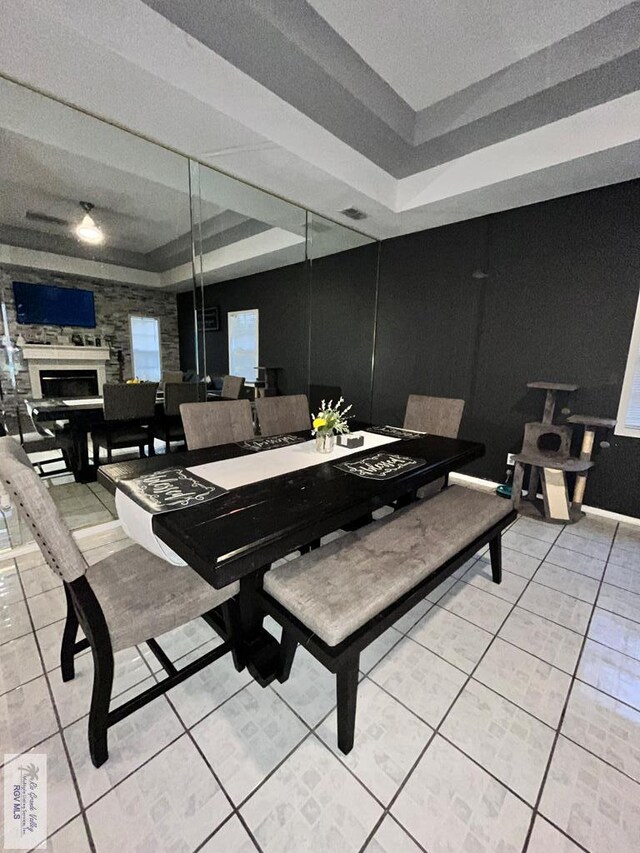 1822 Nasa, Brownsville, TX 78521 - dining space with light tile patterned floors, a raised ceiling, and a fireplace