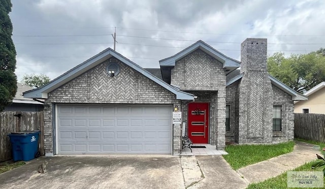 1822 Nasa, Brownsville, TX 78521 - view of front of house featuring driveway, an attached garage, fence, and a chimney