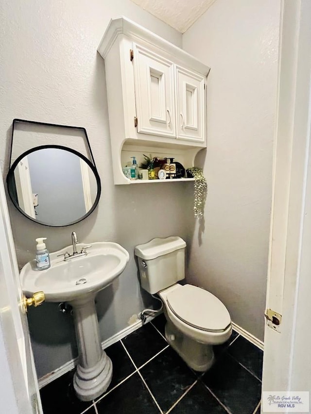 bathroom featuring tile patterned flooring and toilet