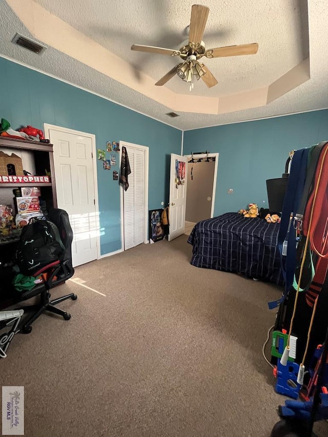1822 Nasa, Brownsville, TX 78521 - carpeted bedroom with a textured ceiling, a raised ceiling, and a ceiling fan
