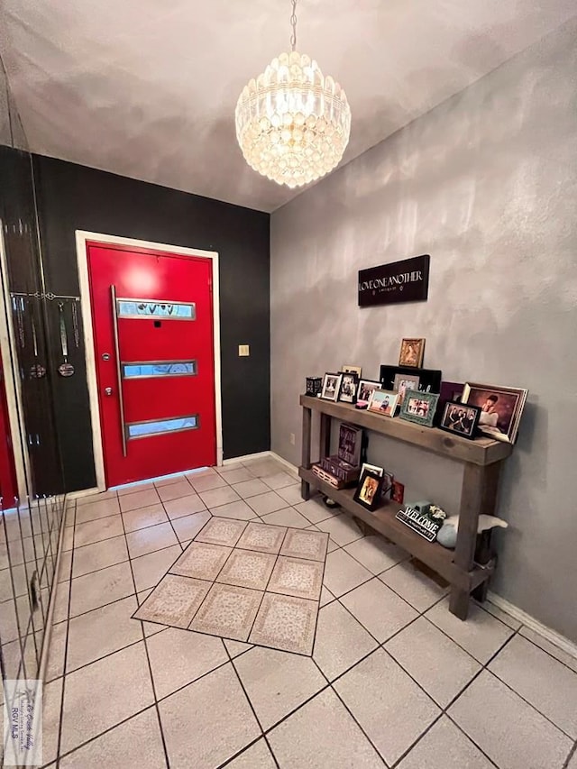 tiled entrance foyer featuring an inviting chandelier