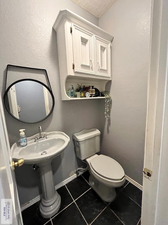 1822 Nasa, Brownsville, TX 78521 - bathroom with tile patterned flooring, toilet, and baseboards