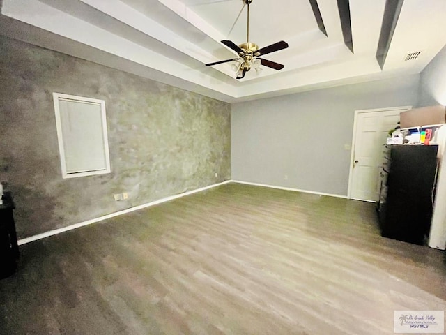 interior space featuring a tray ceiling, ceiling fan, and hardwood / wood-style floors