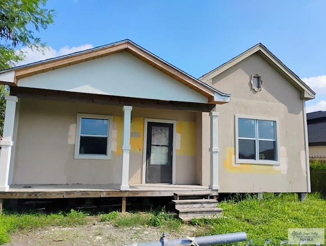 back of house featuring a porch